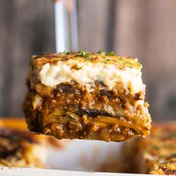 KOVO Greek Street Food - Infused with aromatic spices like cinnamon, nutmeg, and oregano, our Moussaka is a celebration of Mediterranean flavors.