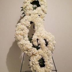 Florals From The Heart - We offer specialty tribute pieces for your loved one.  

Treble Clef funeral tribute for a musician.