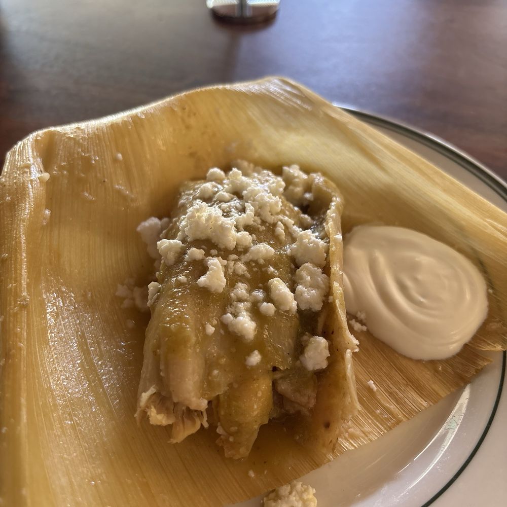 Corazon Comedor - Green chicken chili Verde tamale. Cheese on top and sour cream on the side. - Mexican Near Me - Santa Barbara, California Corazon Comedor - Green chicken chili Verde tamale. Cheese on top and sour cream on the side. - Mexican Near Me - Santa Barbara, California