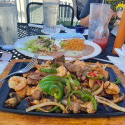 Texans fajitas!A mix of shrimp, steak and chicken with rice, refried beans and salad for under $20.