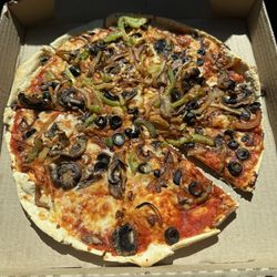 Mama Rosa's Pizza - Medium veggie pizza. Onion, bells, olives and mushrooms on thin crust.   Crust was cracker thin and really good!