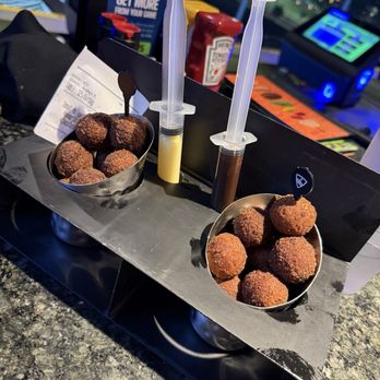 Topgolf - Donut holes with syringes of frosting. Not bad, actually! - Golf Near Me - Montebello, California