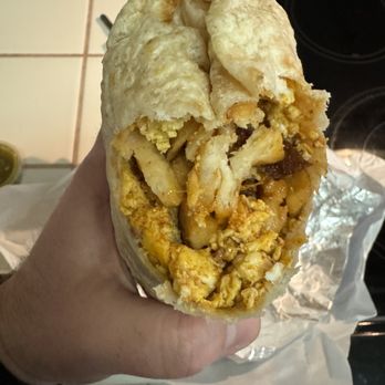 Shop-N-Go - ows a hand holding a breakfast burrito - Grocery Near Me - Fresno, California Shop-N-Go - ows a hand holding a breakfast burrito - Grocery Near Me - Fresno, California