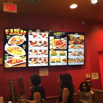 La Granja - a group of people standing in front of a menu - Peruvian Near Me - Lake Worth, Florida La Granja - a group of people standing in front of a menu - Peruvian Near Me - Lake Worth, Florida