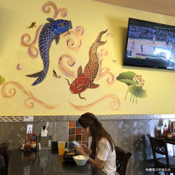 Pho Express - a woman sitting at a table in a restaurant - Vietnamese Near Me Pho Express - a woman sitting at a table in a restaurant - Vietnamese Near Me