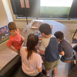 Kids having fundoing puzzles.