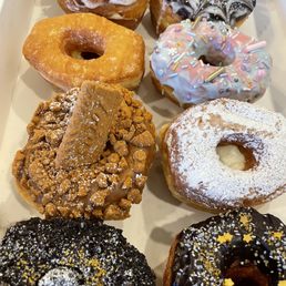 a variety of doughnuts in a box a variety of doughnuts in a box