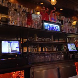 a bar with a lot of glasses on it a bar with a lot of glasses on it