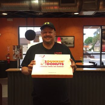 Dunkin' -  a man holding a box of dunkin'donuts - Coffee & Tea Near Me - Kittanning, Pennsylvania