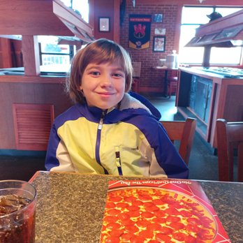 Pizza Hut - a young boy sitting at a table with a pizza - Pizza Near Me - Charleston, West Virginia Pizza Hut - a young boy sitting at a table with a pizza - Pizza Near Me - Charleston, West Virginia