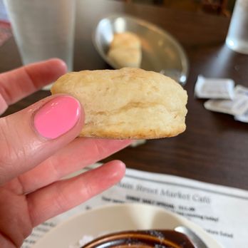 Main Street Market Cafe - a hand holding a biscuit over a bowl of soup - Cajun/Creole Near Me - Vicksburg, Mississippi