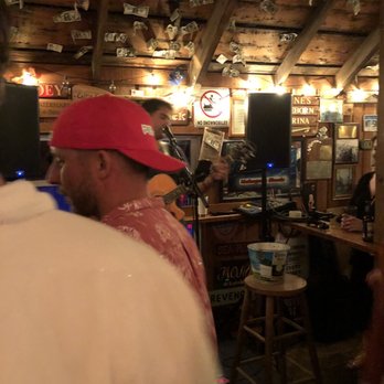 Mahogany Shoals - a man in a red hat at a bar - Bars Near Me - New Shoreham, Rhode Island