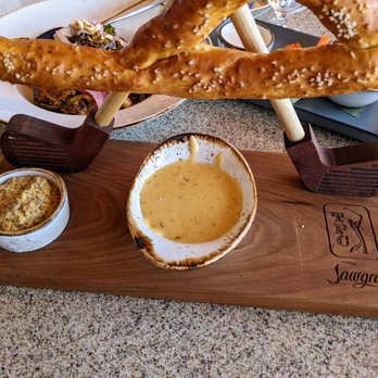 NINETEEN at TPC Sawgrass - TPC Pretzel. $16. Queso + whole grain mustard. It's big and I like the presentation. Here is a close-up of the sauces + TPC Sawgrass logo. - American Near Me - Ponte Vedra Beach, Florida