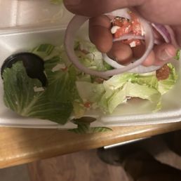 Tomatoes and onions on a salad ordered without Tomatoes and onions on a salad ordered without