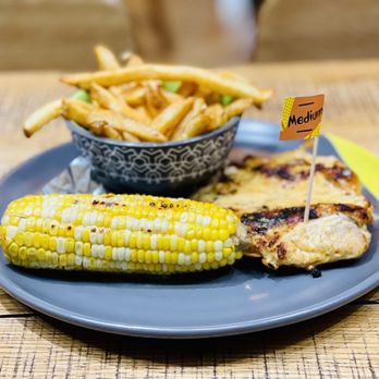 Nando's Peri-Peri - Boneless chicken breast with peri-peri chips and grilled corn cob as sides. - Chicken Shop Near Me - Chicago, Illinois Nando's Peri-Peri - Boneless chicken breast with peri-peri chips and grilled corn cob as sides. - Chicken Shop Near Me - Chicago, Illinois