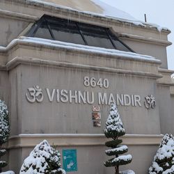 Vishnu Mandir - Sign with snow-covered trees