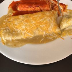 Beef burrito smothered in green sauce and tamale in red