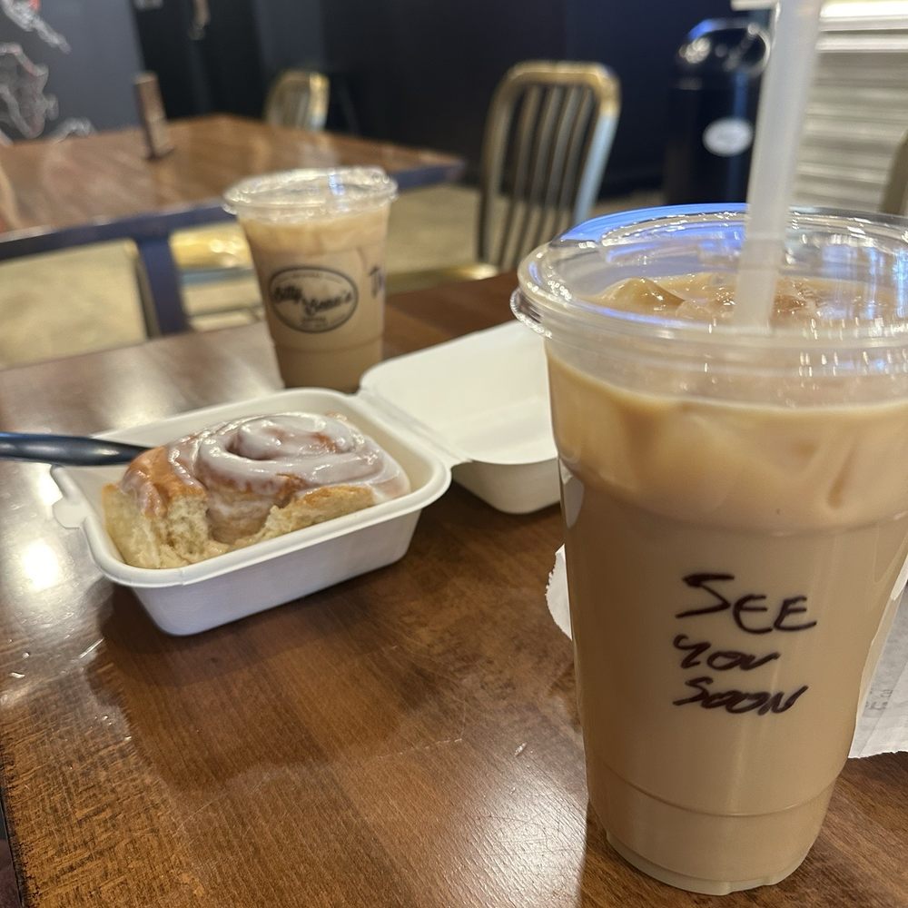 Two iced lattes and a cinnamon roll. Two iced lattes and a cinnamon roll.