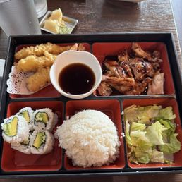 Bento box, Shrimp Tempura, Teriyaki chicken, Avocado sushi with sauce. Bento box, Shrimp Tempura, Teriyaki chicken, Avocado sushi with sauce.