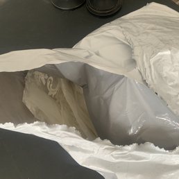 Crumpled up dress, shoved in a shipping bag without any inner protection. Crumpled up dress, shoved in a shipping bag without any inner protection.