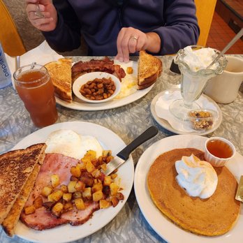 Henrys Diner - a woman eating breakfast - Diners Near Me - Burlington, Vermont