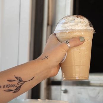 Agape Grounds - a hand holding a cup of iced coffee - Coffee & Tea Near Me - Ione, California Agape Grounds - a hand holding a cup of iced coffee - Coffee & Tea Near Me - Ione, California
