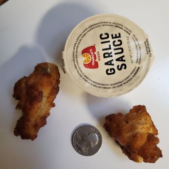 Marco's Pizza - two pieces of fried chicken next to a cup of sauce - Pizza Near Me - Oviedo, Florida