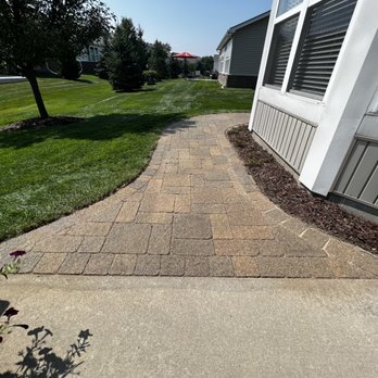 American Skilled Trade Services - a walkway leading to a house - Landscaping Near Me