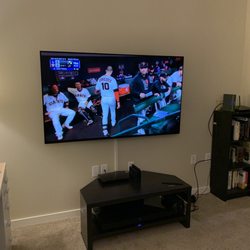 65 inch TV wall mounted with surface track.