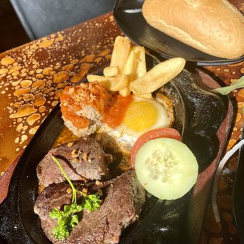 Pho Time - sizzling filet mignon plate with an incredible shumai style meatball. - Vietnamese Near Me - San Diego, California Pho Time - sizzling filet mignon plate with an incredible shumai style meatball. - Vietnamese Near Me - San Diego, California