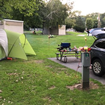 Merry Mac's Campground - Campsite with electricity and water, fire pit is behind our folding chair and tiki torches. - Campgrounds Near Me - Merrimac, Wisconsin Merry Mac's Campground - Campsite with electricity and water, fire pit is behind our folding chair and tiki torches. - Campgrounds Near Me - Merrimac, Wisconsin
