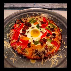 Bar Z Everett - Breakfast pizza with sausage Canadian bacon and regular bacon peppers onions and a fried egg