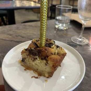 Flora - Birthday chocolate chip bread pudding with fancy gold candle - Breakfast & Brunch Near Me - San Diego, California Flora - Birthday chocolate chip bread pudding with fancy gold candle - Breakfast & Brunch Near Me - San Diego, California