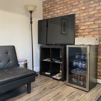 Heavy Hearts Tattoo - downstairs waiting area, with the beverage fridge and TV equipped with Netflix, ready to go for customers having to wait a while - Tattoo Near Me - Houston, Texas Heavy Hearts Tattoo - downstairs waiting area, with the beverage fridge and TV equipped with Netflix, ready to go for customers having to wait a while - Tattoo Near Me - Houston, Texas