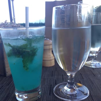 the C restaurant + bar - The "Big Blue Live" happy hour Mojito, compared to the complimentary water glass beside it......so small :( - Seafood Near Me - Monterey, California the C restaurant + bar - The "Big Blue Live" happy hour Mojito, compared to the complimentary water glass beside it......so small :( - Seafood Near Me - Monterey, California