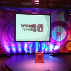 Sound Wave Events - Uplighting to enhance the cool art deco backdrop I rented. Synced to a light board, to change color throughout the program.