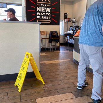 Smashburger - a yellow caution sign in a restaurant - Burgers Near Me - Colorado Springs, Colorado Smashburger - a yellow caution sign in a restaurant - Burgers Near Me - Colorado Springs, Colorado