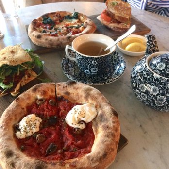 The Allis - (Front) halloumi & charred cauliflower and burrata pizza, (back) arrabbiata pizza and roast turkey club w/ jasmine pearl tea - Lounges Near Me - Chicago, Illinois The Allis - (Front) halloumi & charred cauliflower and burrata pizza, (back) arrabbiata pizza and roast turkey club w/ jasmine pearl tea - Lounges Near Me - Chicago, Illinois
