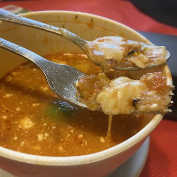 Taqueria El Compadre - Glob of cheese in the chicken soup that has a spoonful of chicken in it. - Mexican Near Me - Modesto, California