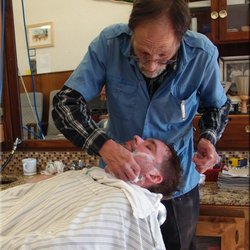 Retro Barbers - David giving a straight razor shave. He has only been doing this for 55 years.