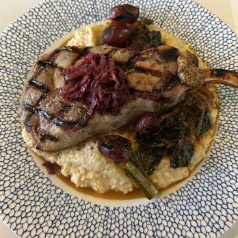 Copper Vine Inn - Bourbon Grilled Pork Chop with grits, greens and grilled grapes - Wine Bars Near Me - New Orleans, Louisiana