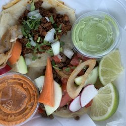 Tacos Tikos - Taco al pastor and a hidden taco de carne asada with an assortment of raw and pickled veggies.