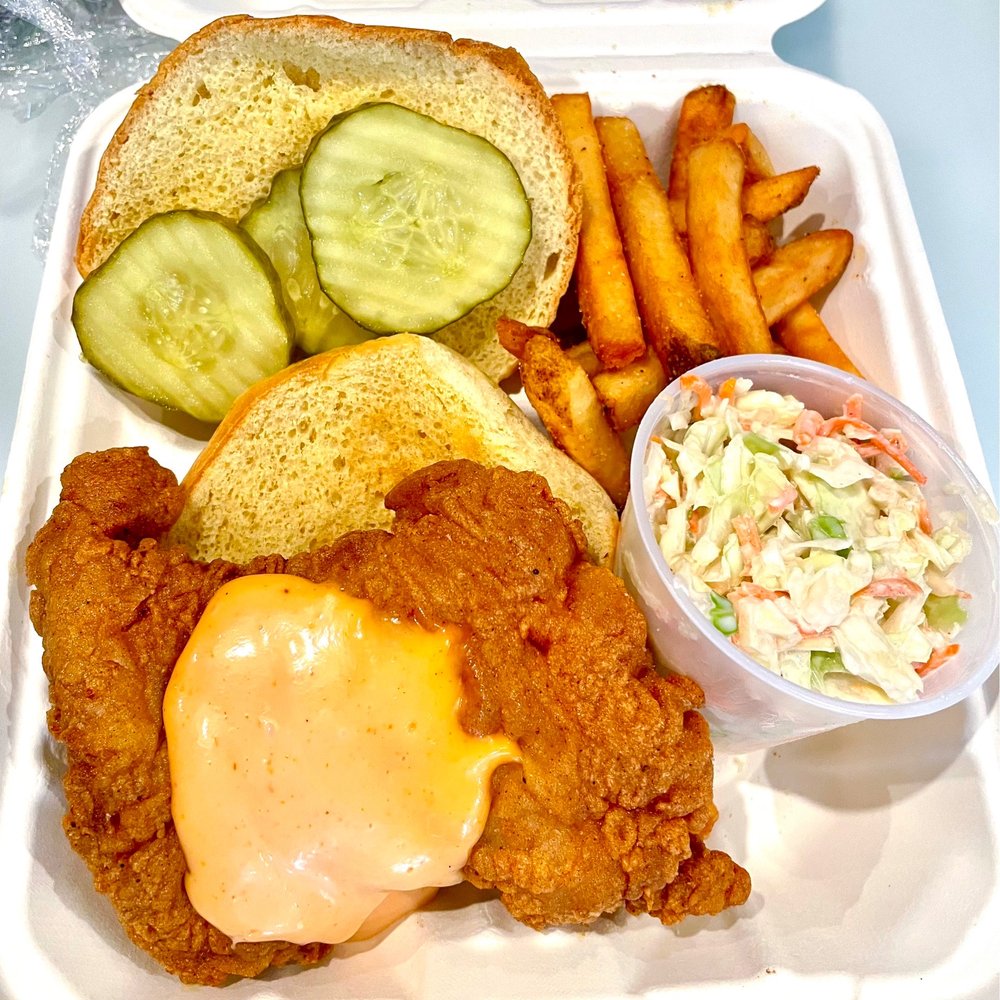 The Pike - Fried chicken thigh served on a brioche roll with the Pike sauce and pickles. Served with fries and coleslaw. - Food Trucks Near Me - Water Mill, New York The Pike - Fried chicken thigh served on a brioche roll with the Pike sauce and pickles. Served with fries and coleslaw. - Food Trucks Near Me - Water Mill, New York