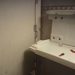 Broken baby changing area wouldn't stay up so blocked door to a stall