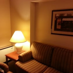 Stage West All Suite Hotel & Theatre Restaurant - Living area with couch and chair