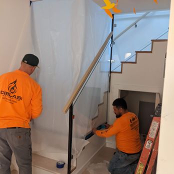 DiBlasi Restoration - two men working on a staircase - Damage Restoration Near Me