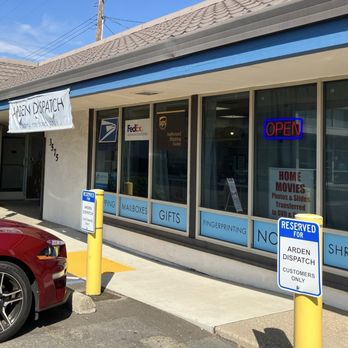 Arden Dispatch - Parking - Arden Dispatch's storefront features large windows with service signs, an open sign, and reserved parking for customers, including designated spots for the store. - Shipping Centers Near Me - Sacramento, California