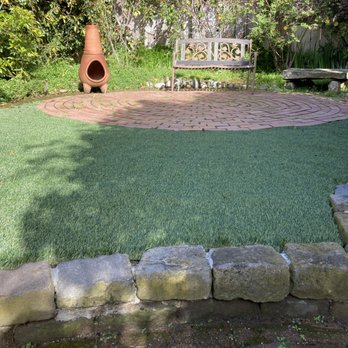 Blooms Gardening - a garden with a brick patio - Landscaping Near Me Blooms Gardening - a garden with a brick patio - Landscaping Near Me