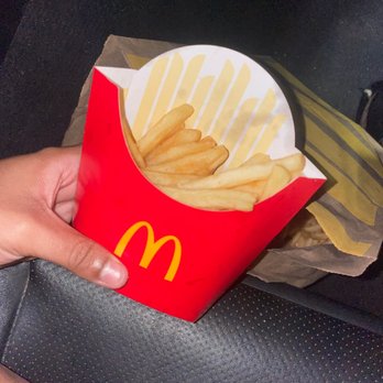 McDonald's - a hand holding a box of french fries - Fast Food Near Me - Kissimmee, Florida McDonald's - a hand holding a box of french fries - Fast Food Near Me - Kissimmee, Florida
