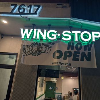 Wingstop - The "Wing Stop" sign lit up at night. - Chicken Wings Near Me - West Hollywood, California Wingstop - The "Wing Stop" sign lit up at night. - Chicken Wings Near Me - West Hollywood, California